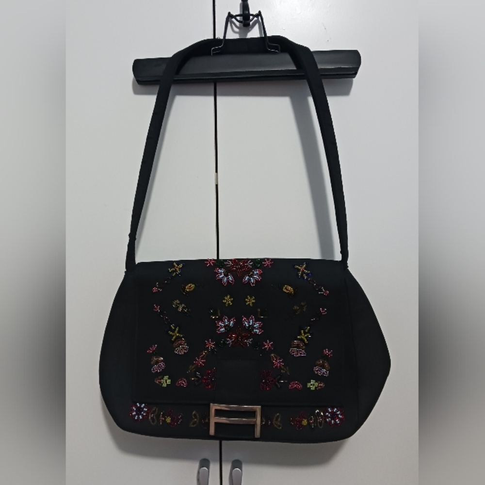 Black handbag with a floral design embroidered with colorful beads.